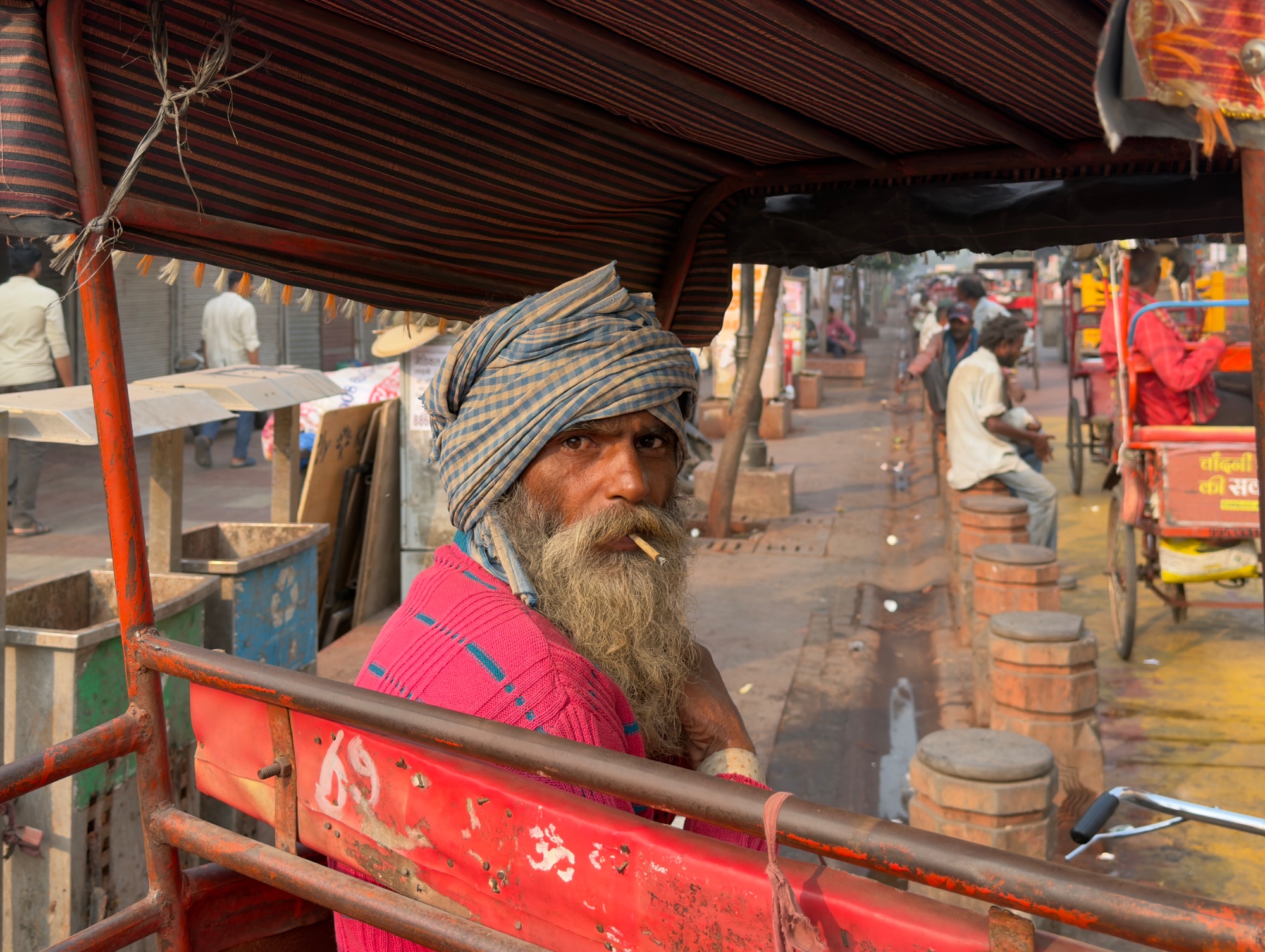 The Rickshaw Driver's Gaze — street photo by Les Zackler, scored 8.1/10 by REVIEWR's AI critique