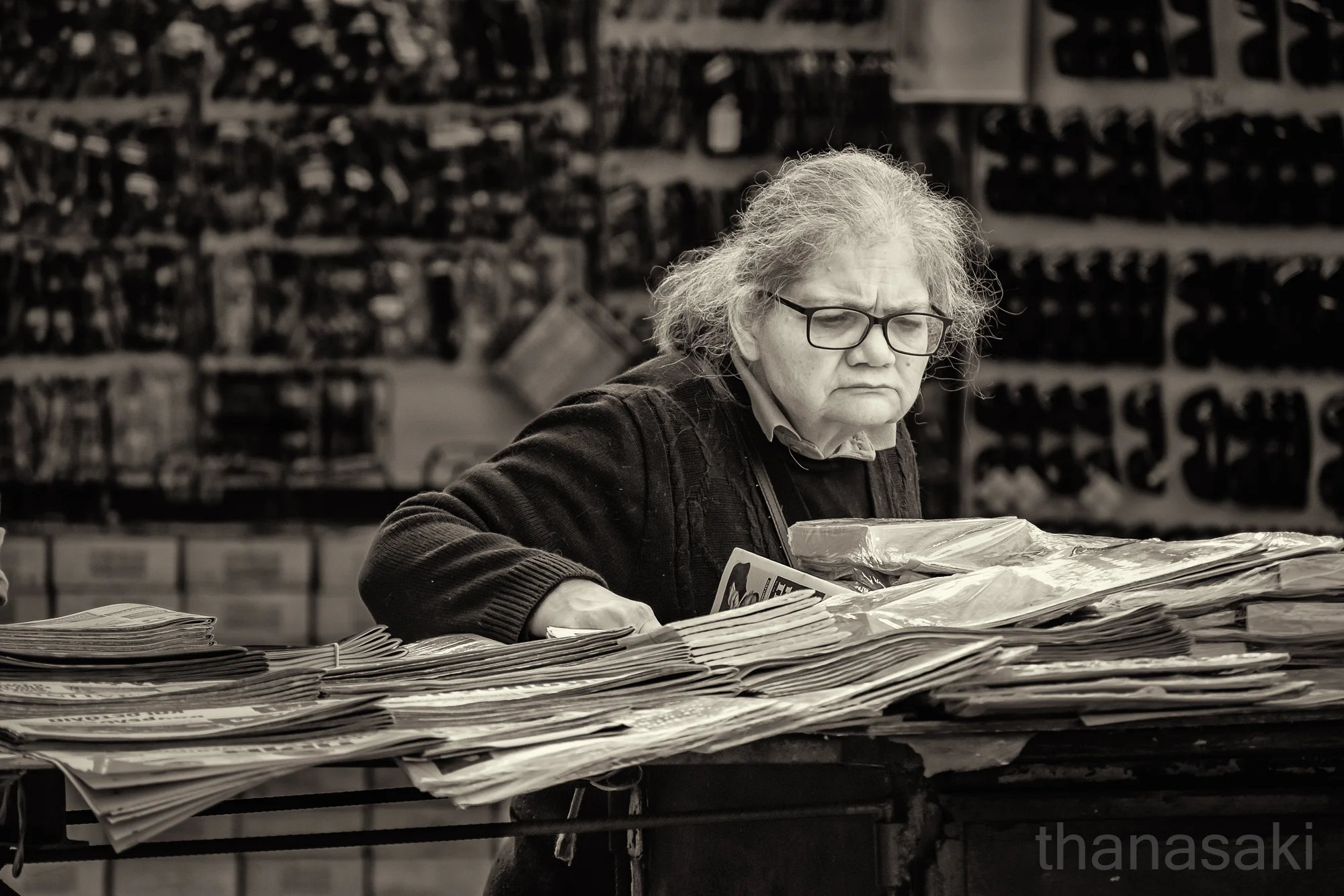 Reading the Headlines — street photo by thanasaki, scored 7.4/10 by REVIEWR's AI critique